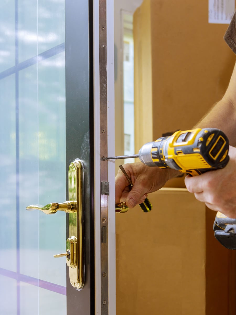 door installer drilling into the side of a door